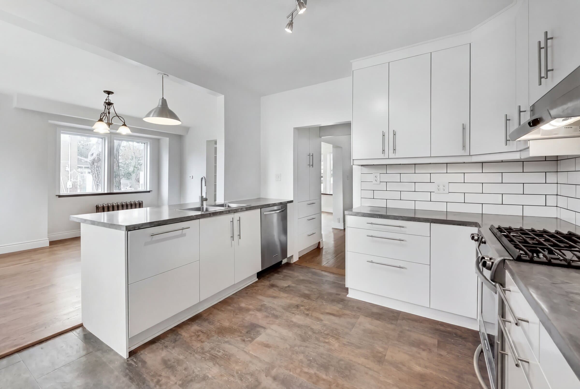 Renovated kitchen with white shaker cabinets, subway tile backsplash, and stainless steel appliances — Alhambra project