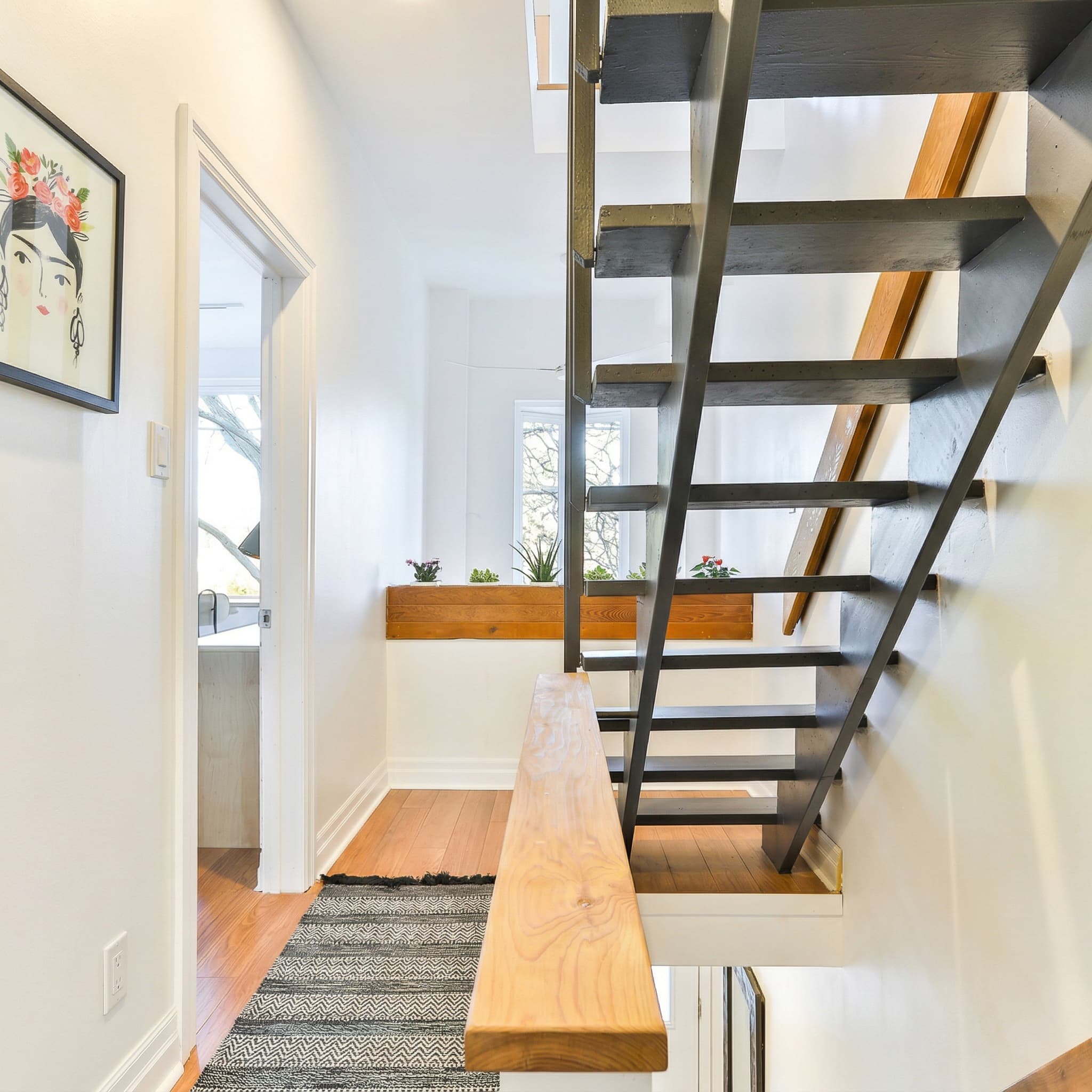 Custom floating staircase with steel stringers, wood treads, and live-edge bench — 36 Ford Street